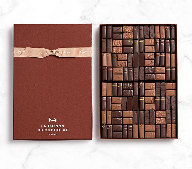 Coffret Maison Dark and Milk 112 chocolates on marble background