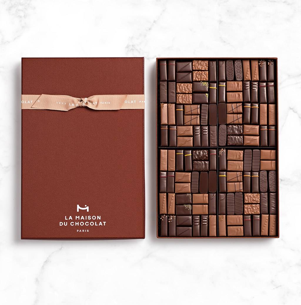 Coffret Maison Dark and Milk 112 chocolates on marble background 