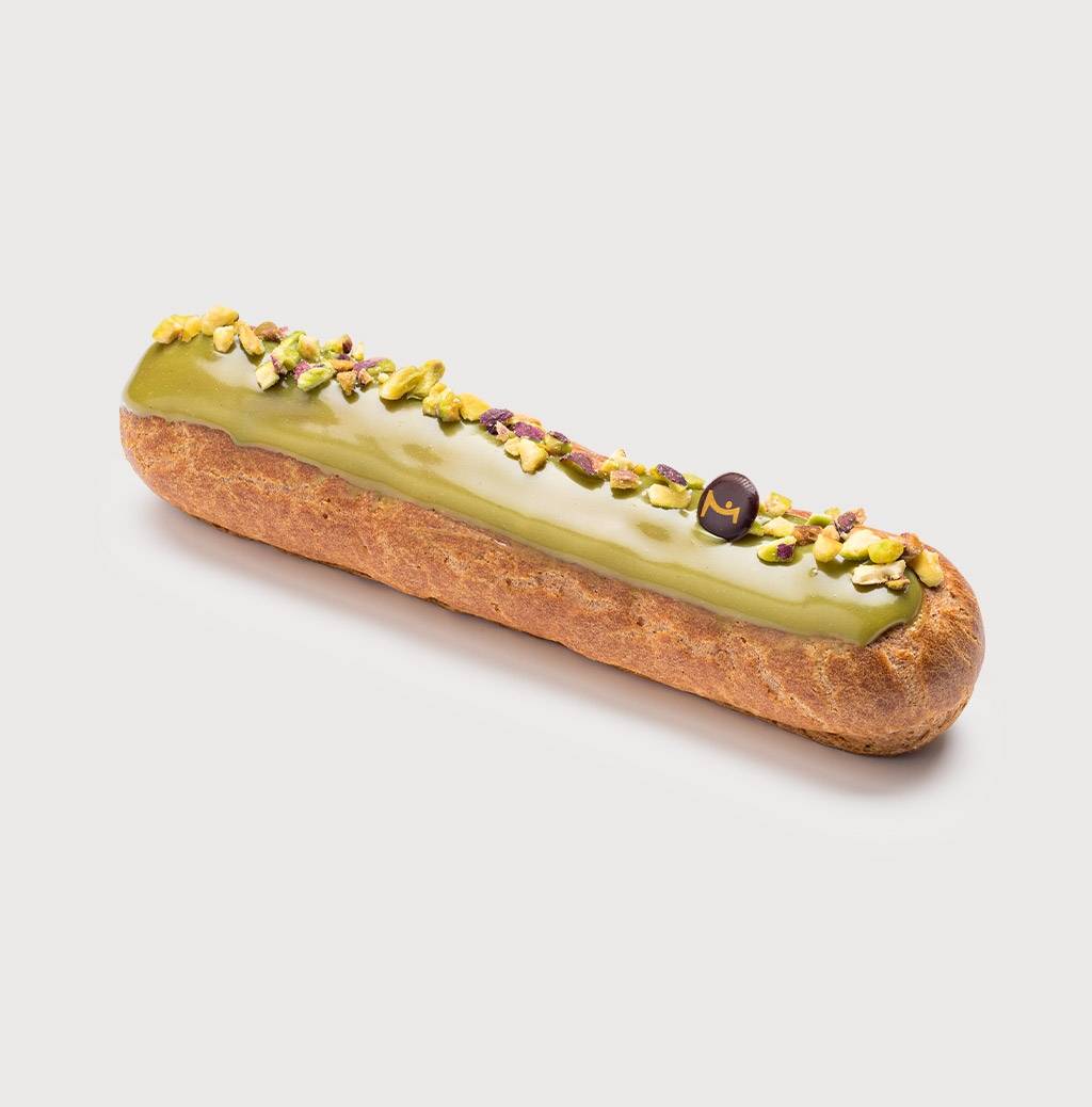 Pistachio Eclair on a grey background