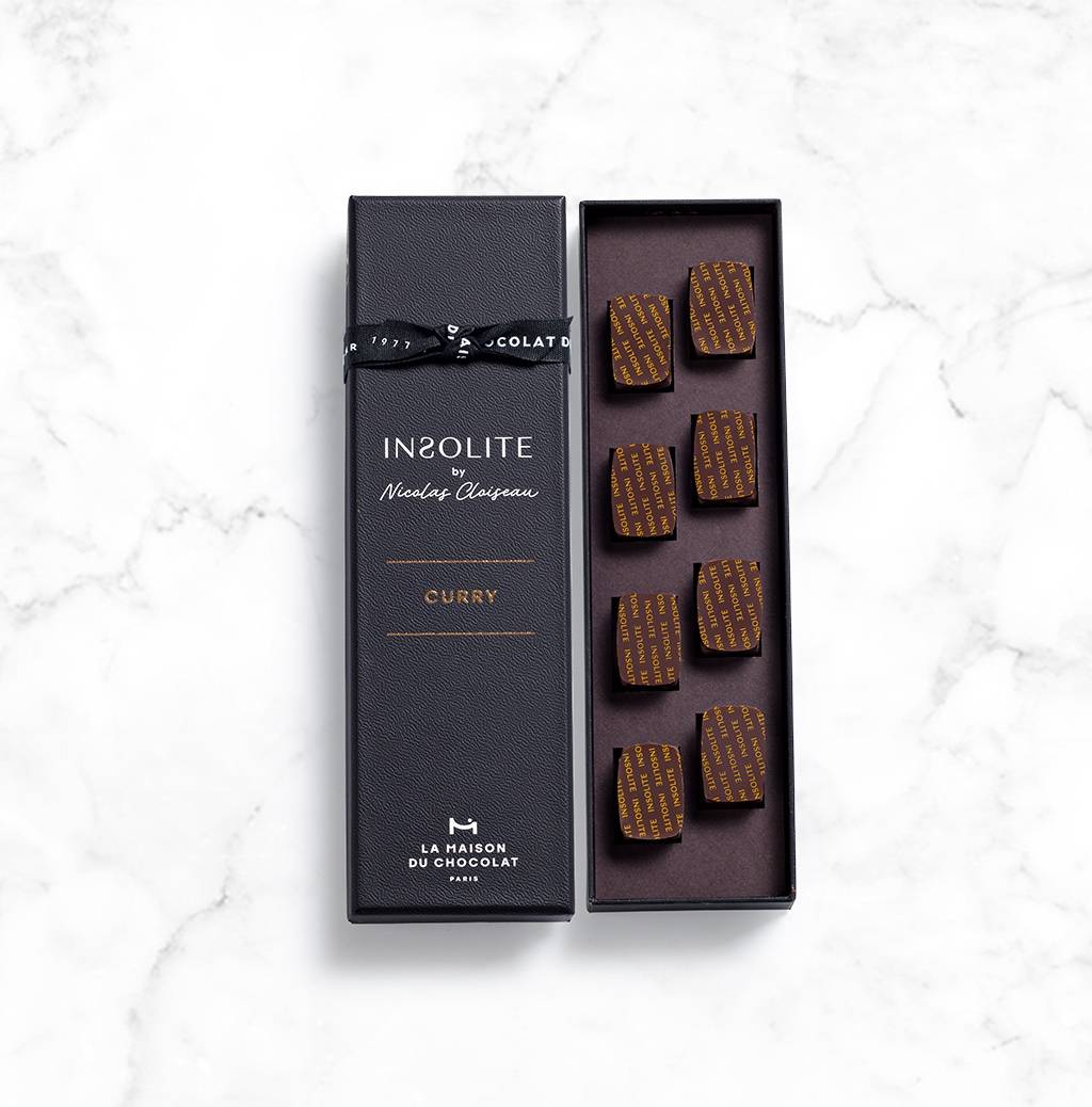 Insolite curry chocolate box on marble background
