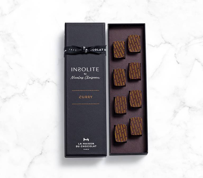 Insolite curry chocolate box on marble background