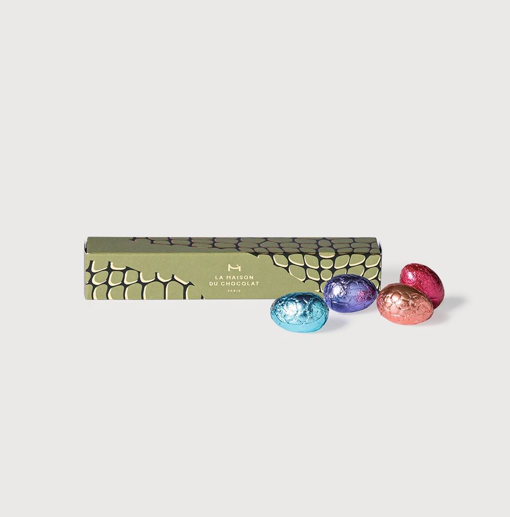 Dark & Milk Chocolate Praliné Eggs Tube on a grey background