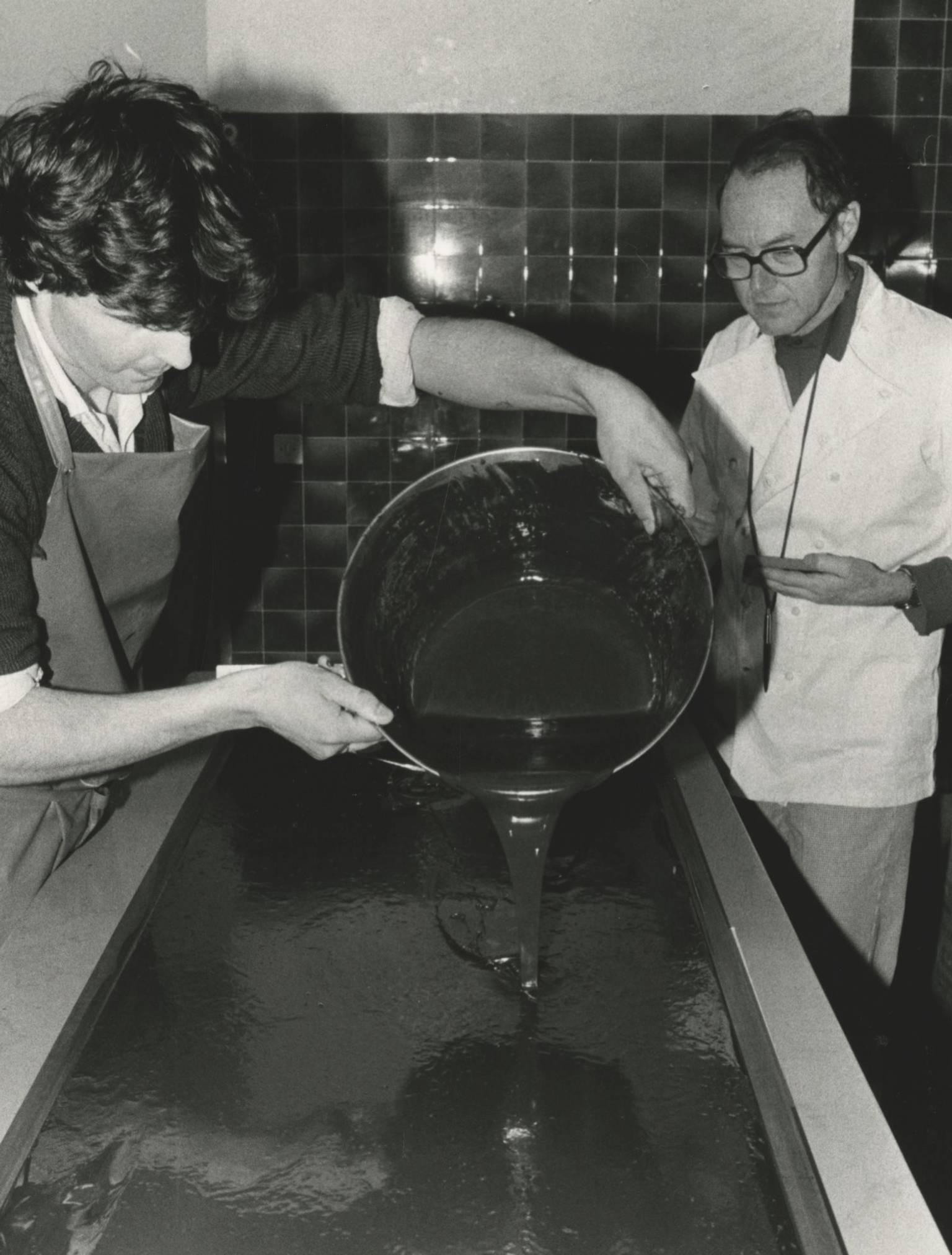 Robert Linxe pouring ganache onto marble in black and white