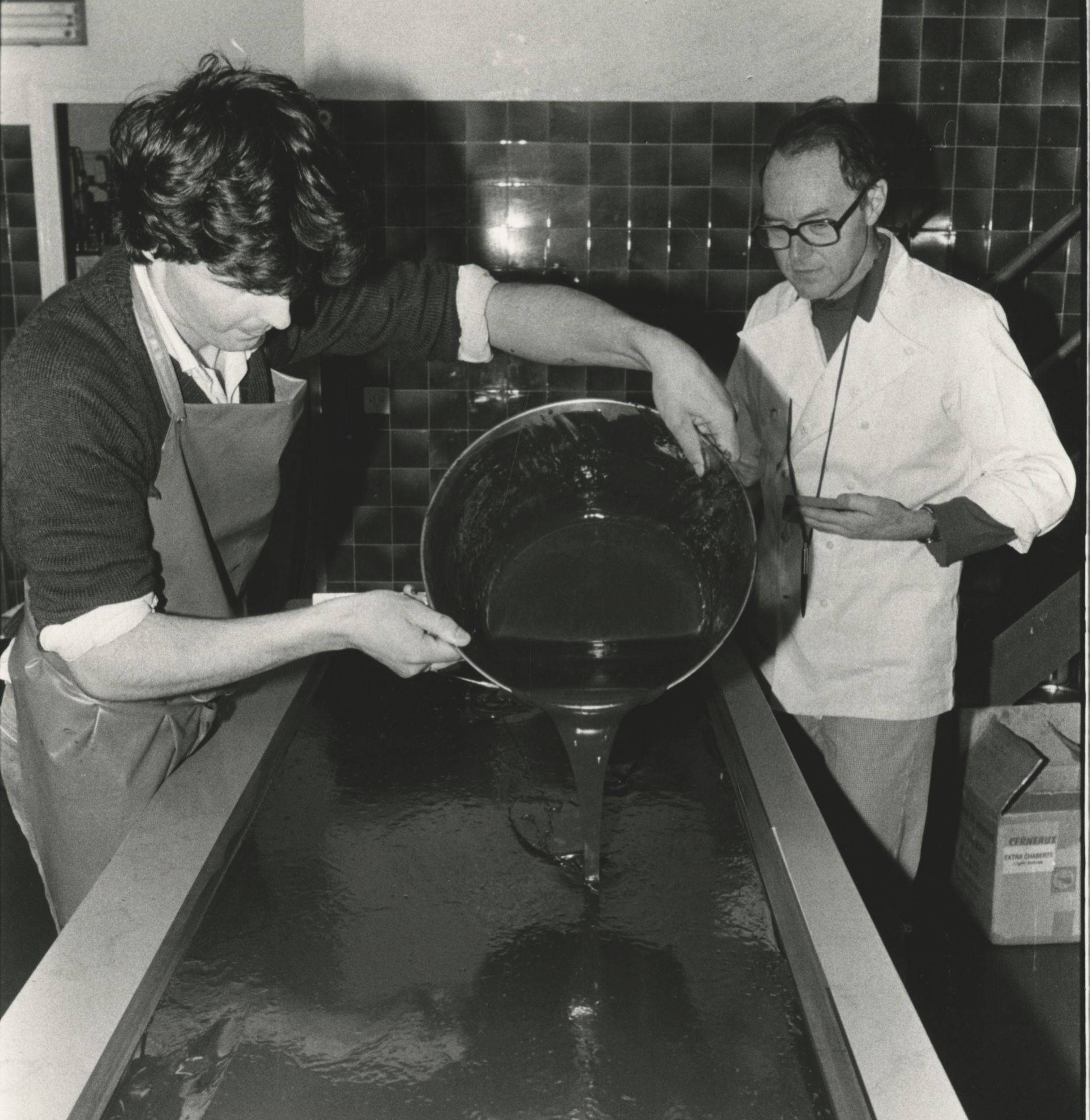 Robert Linxe pouring ganache onto marble in black and white
