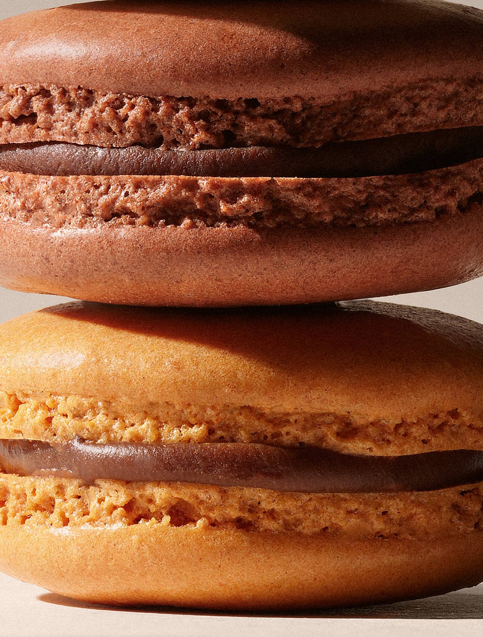 close up photo of chocolate filled macarons