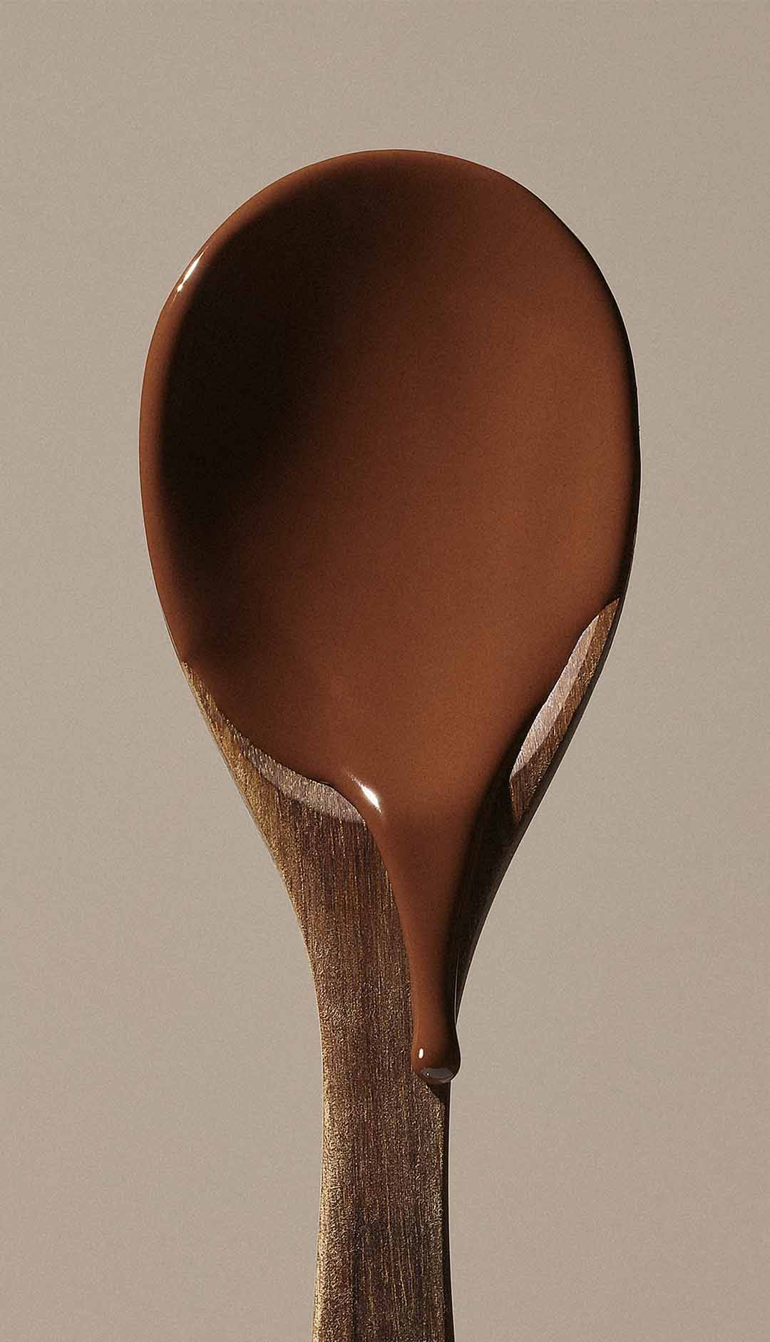 Wood spoon with melted chocolate